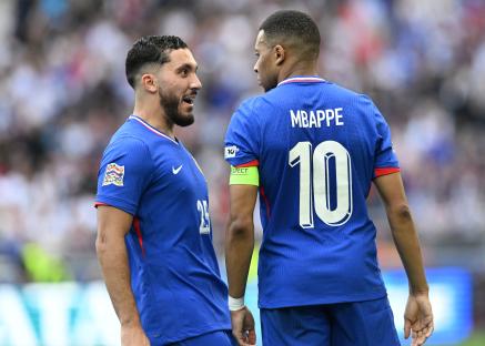 Kylian Mbappé and Rayan Cherki celebrating a goal.