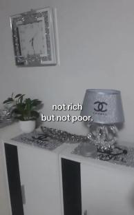Silver Chanel-themed décor on a white dresser.