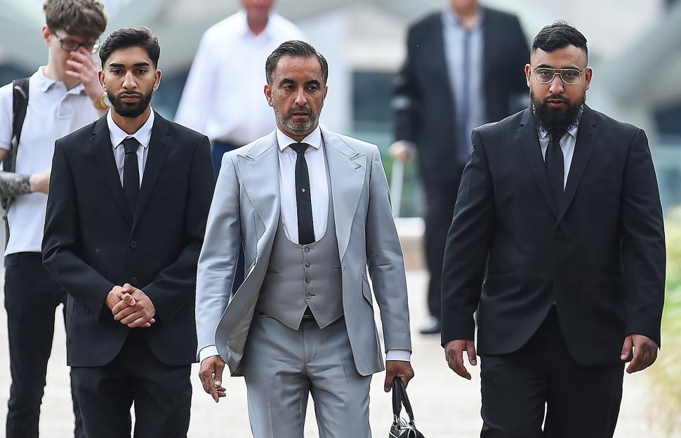 Three men in suits arrive at Liverpool Crown Court.