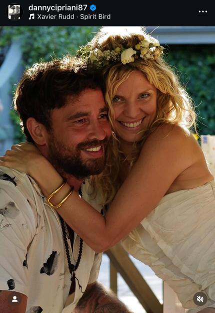 Couple embracing; woman wears flower crown.