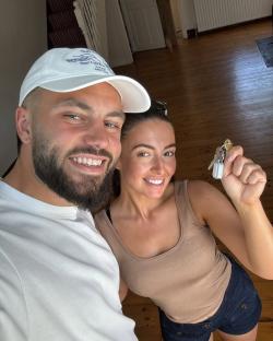 Finn Tapp and his girlfriend holding house keys.