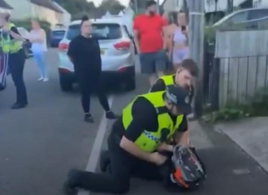 Police officer arresting a biker.