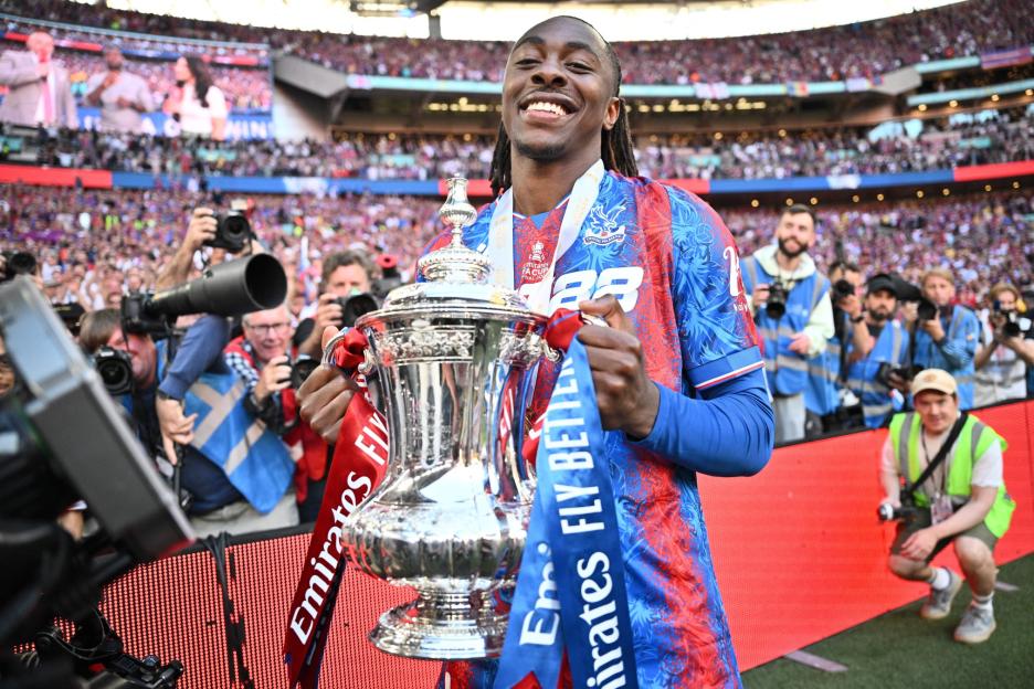 Eberechi Eze of Crystal Palace holding the Emirates FA Cup trophy.