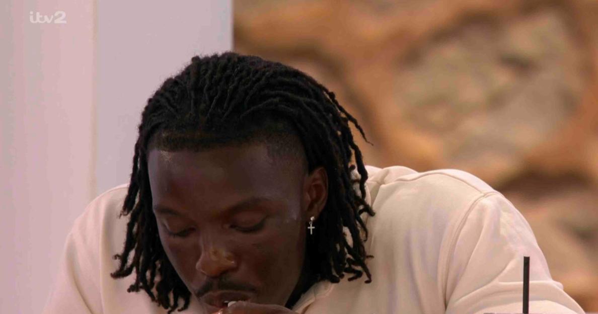 Dejon eating pasta while ignoring Yasmin.