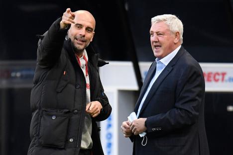 Pep Guardiola and Steve Bruce talking before a soccer match.