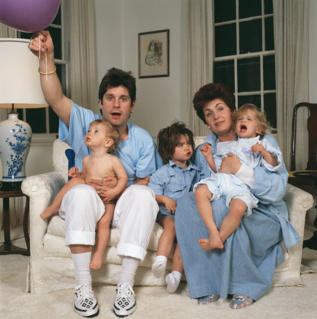 Family portrait of a man, woman, and three young children.