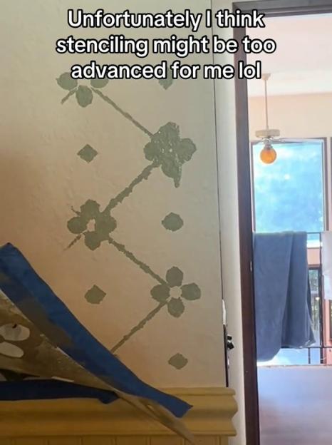Unsuccessful DIY stenciling on a bedroom wall.