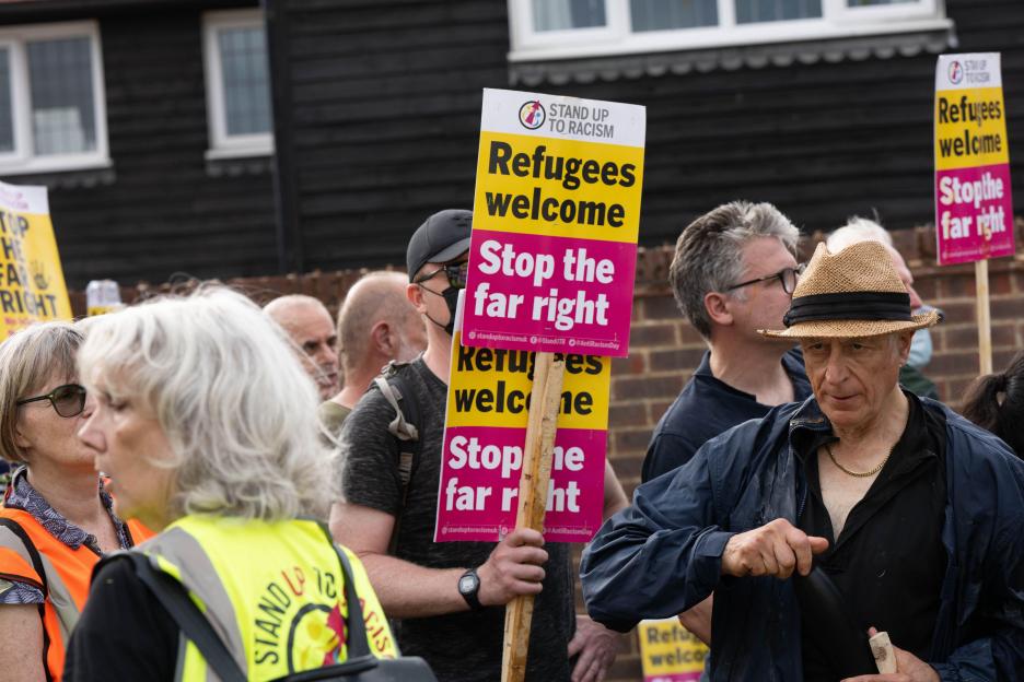 Pro-immigrant protesters holding signs that read 