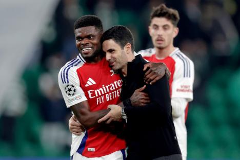 Thomas Partey and Mikel Arteta embracing after an Arsenal victory.