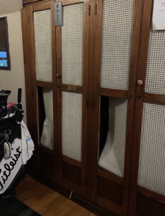 Wooden locker with cane inserts.