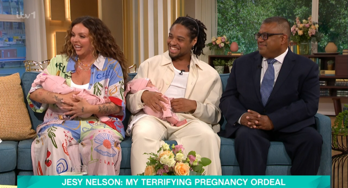 Jesy Nelson and her partner holding their twin babies on a talk show.