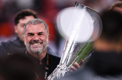 Ange Postecoglou holding the UEFA Europa League trophy.
