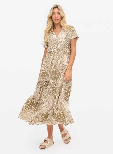 Woman wearing a patterned midi dress.