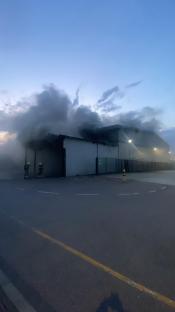 Firefighters battling a large warehouse fire.