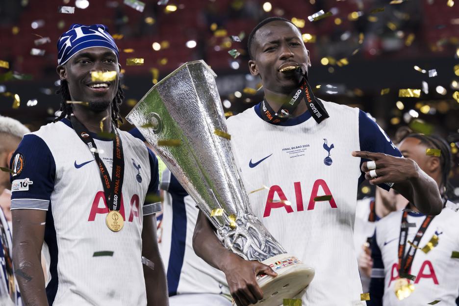 Tottenham Hotspur players celebrating with the UEFA Europa League trophy.