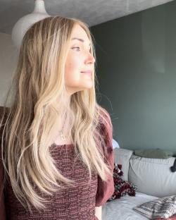 Woman with long blonde hair looking off to the side.