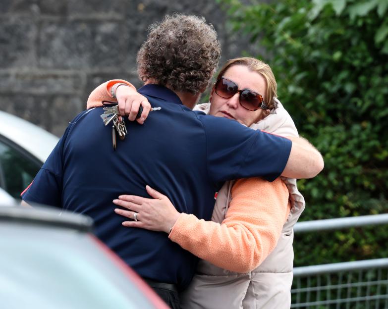 Lisa Flaherty hugging a relative outside Tullamore Coroner's Court.