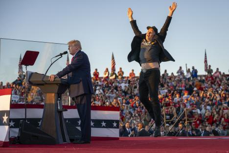Elon Musk jumping on stage at a Donald Trump rally.