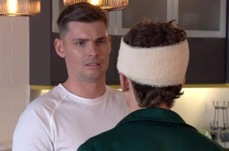 A man with a head injury confronts another man.