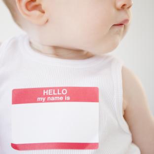 Baby wearing a blank name tag that says