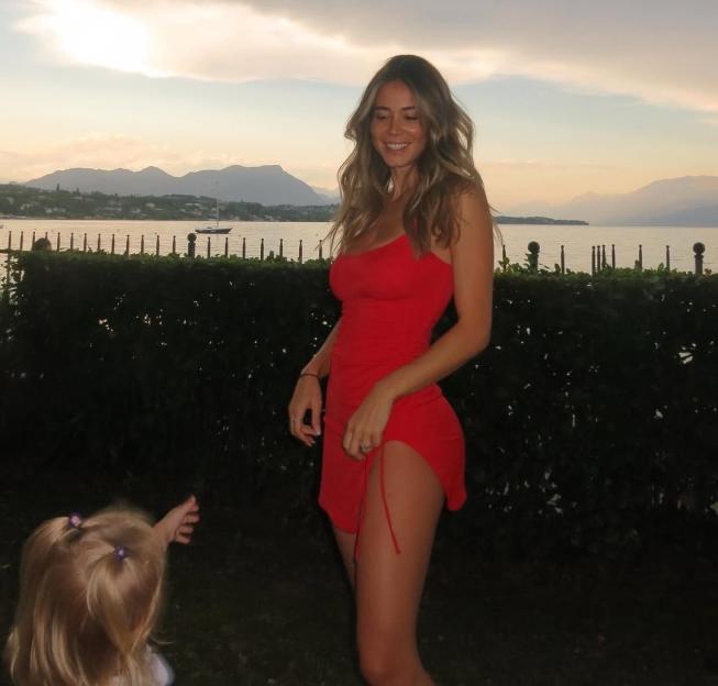 Woman in red dress by the sea.