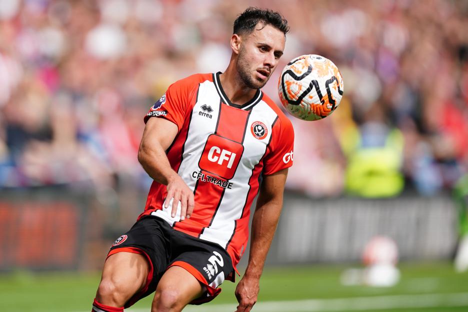 George Baldock of Sheffield United controlling a soccer ball.