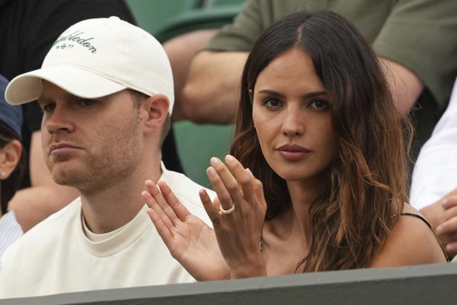 Eiza GonzÃ¡lez watching Grigor Dimitrov play tennis at Wimbledon.