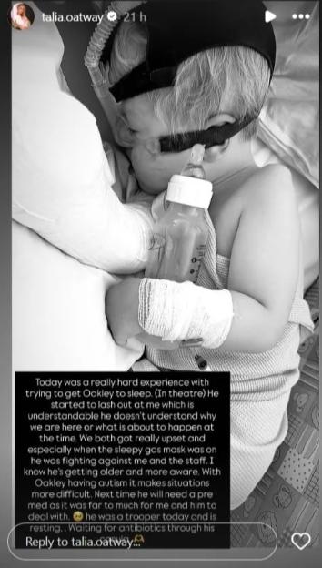 Black and white photo of a baby in a hospital bed receiving medical treatment.