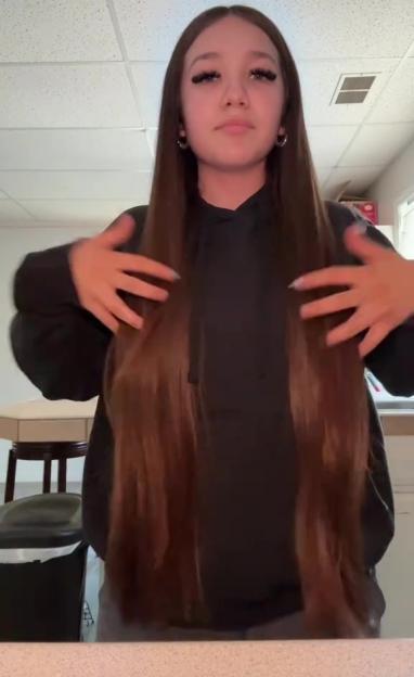 Woman showing off her long hair.