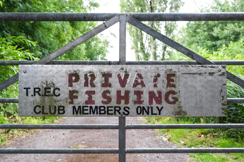 Private fishing club members only sign on gate.