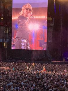 Robbie Williams performing at a packed Emirates Stadium.