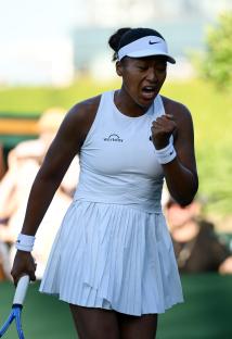 Naomi Osaka celebrating a tennis match victory.