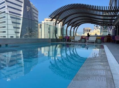 Rooftop pool with city view.