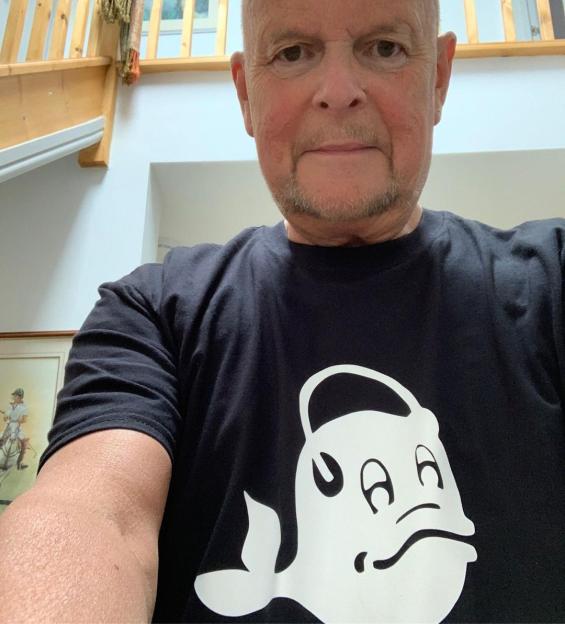 Man wearing a black t-shirt with a white whale design.