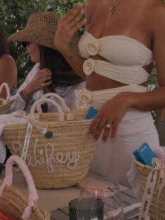 A woman in a white crop top and skirt at a bachelorette party.