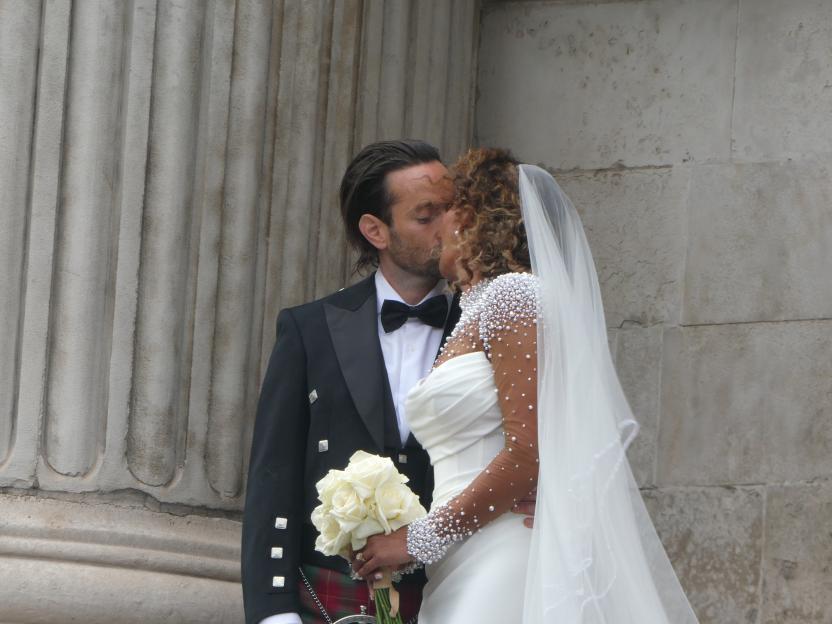 Mel B and Rory Mcphee kissing at their wedding.