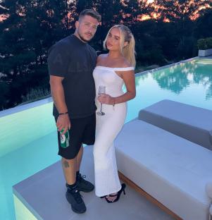 Couple by a pool at sunset.