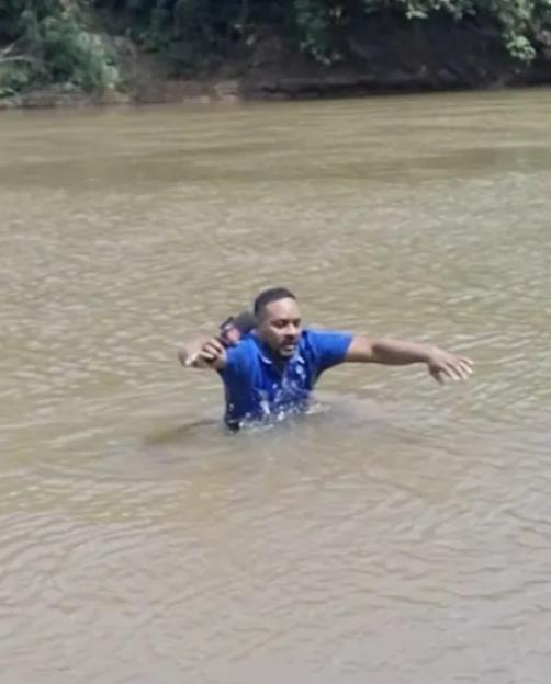 Reporter in river, possibly having accidentally touched the body of a missing girl.