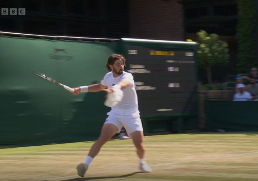 Tennis player hitting a forehand.