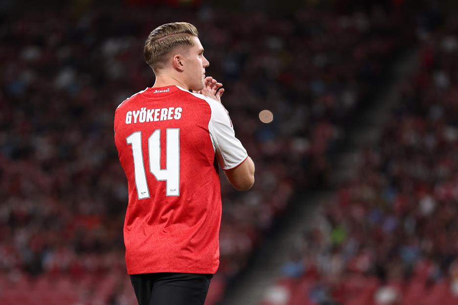 Viktor Gyokeres, number 14, in an Arsenal jersey, applauds fans.