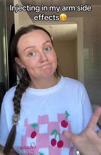 Woman describing arm side effects from an injection.