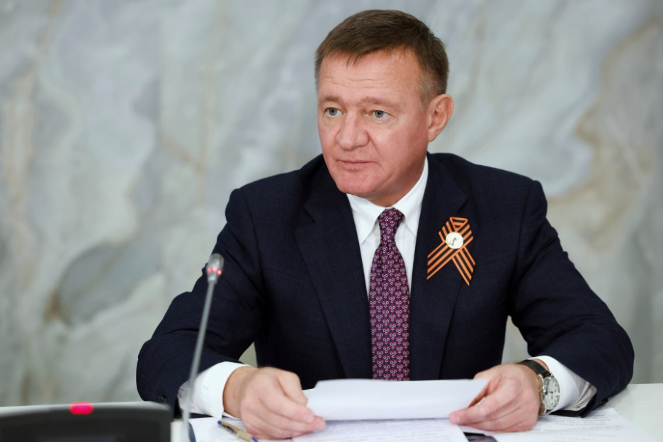 A man in a suit reviewing documents.
