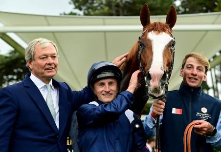Jockey Tom Marquand, owner, and trainer with winning horse Economics after the Royal Bahrain Irish Champion Stakes.