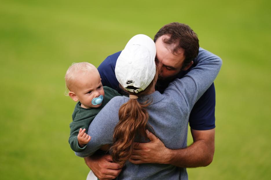 Scottie Scheffler celebrates with his wife and son after winning The Open.