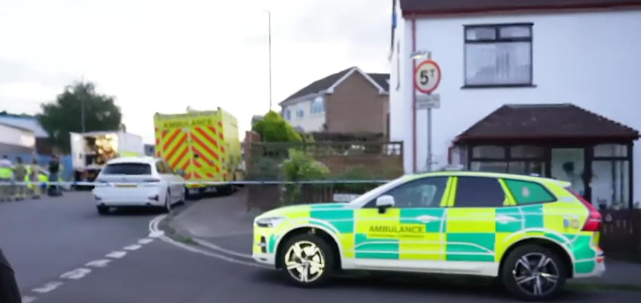 Emergency vehicles and police tape at a residential street during a bomb scare.