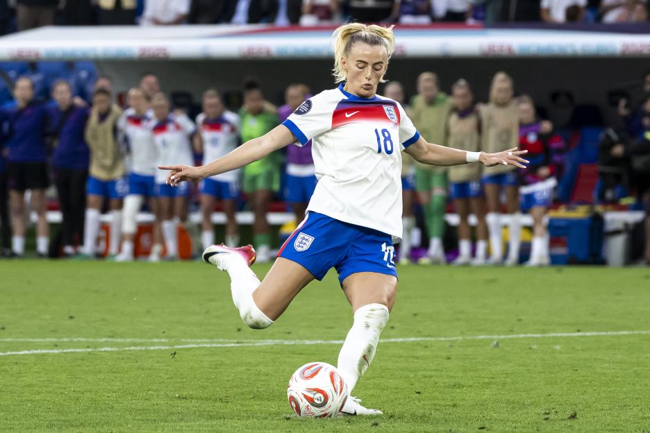 Chloe Kelly, #18, kicks a soccer ball during a penalty shootout.