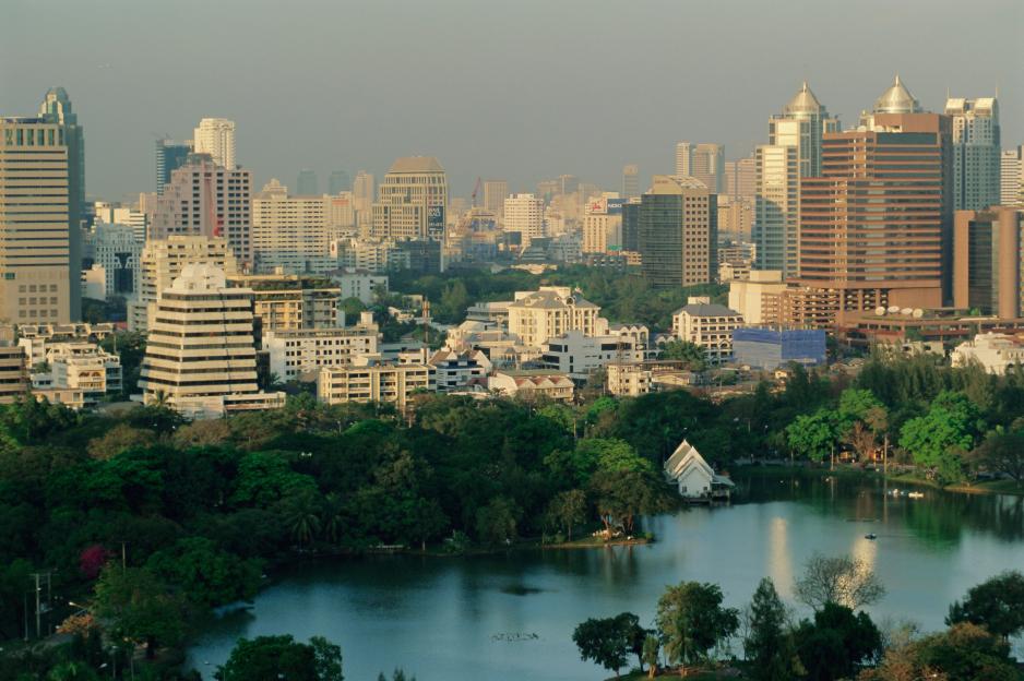 Bangkok skyline over Lumphini Park.
