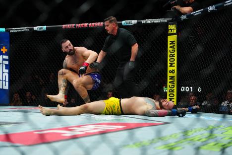 Paul Craig standing over a downed Rodolfo Bellato in a UFC match.