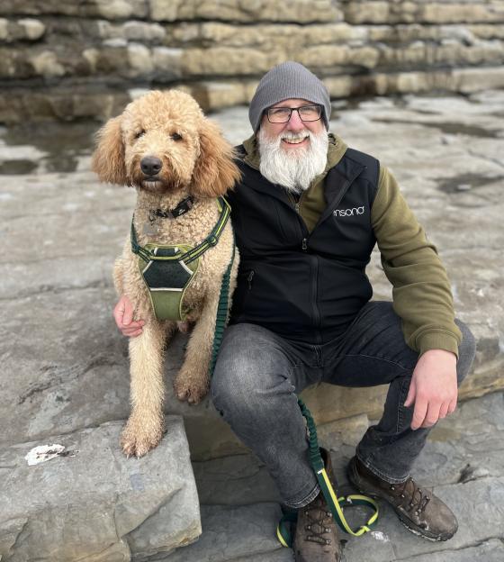 Man sitting with his large dog.