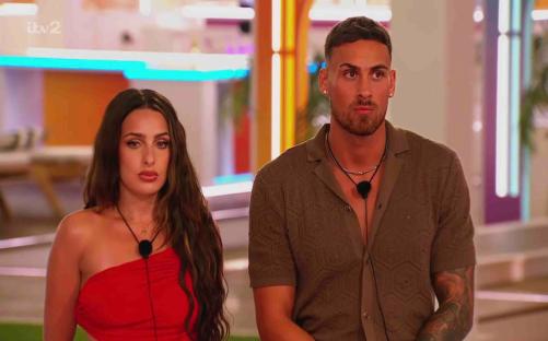 A man and woman sitting together in the Love Island villa.
